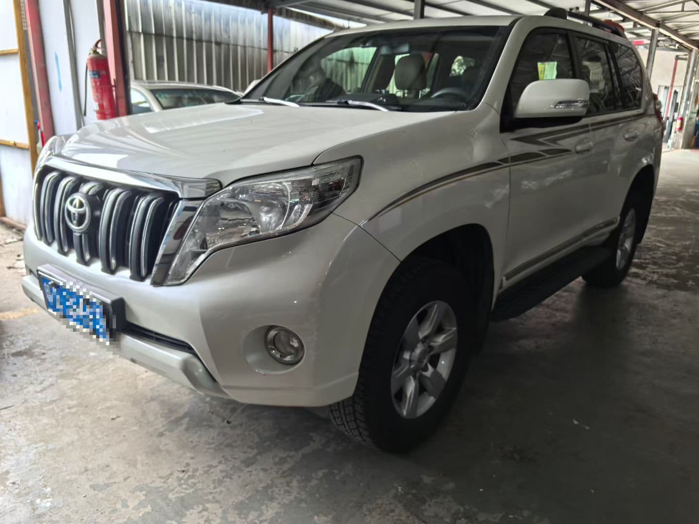 White Toyota Prado large SUV